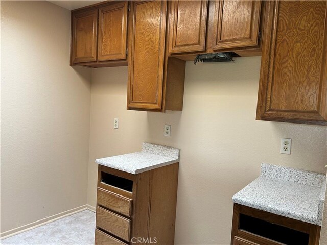 4499 Via Marisol Unit 327, Los Angeles, CA 90042 - laundry room featuring baseboards