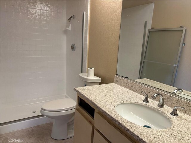 4499 Via Marisol Unit 327, Los Angeles, CA 90042 - bathroom featuring vanity, tiled shower, tile patterned floors, and a textured wall