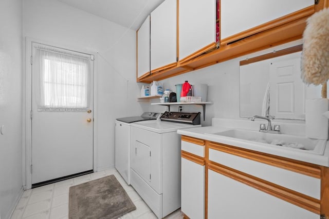 clothes washing area featuring washing machine and clothes dryer and cabinet space