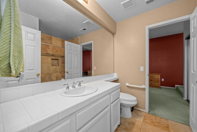 full bathroom featuring toilet, vanity, a shower, tile patterned floors, and baseboards