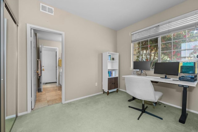 home office with light carpet and baseboards
