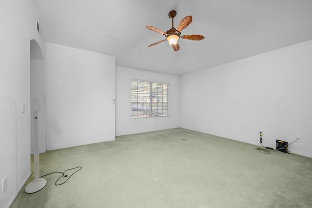 carpeted spare room featuring ceiling fan