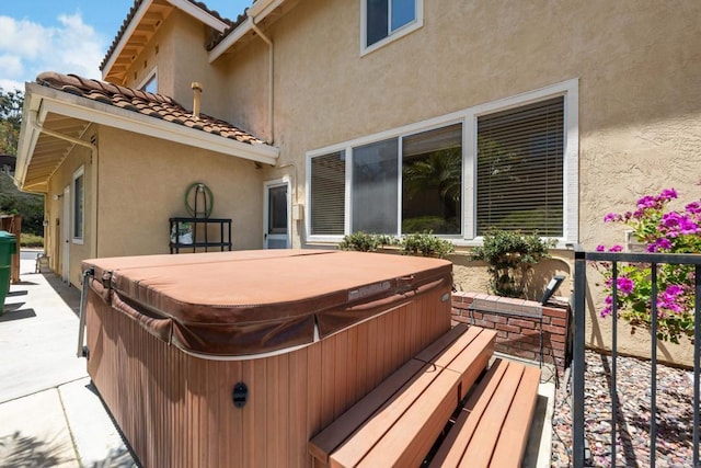 wooden terrace featuring a hot tub