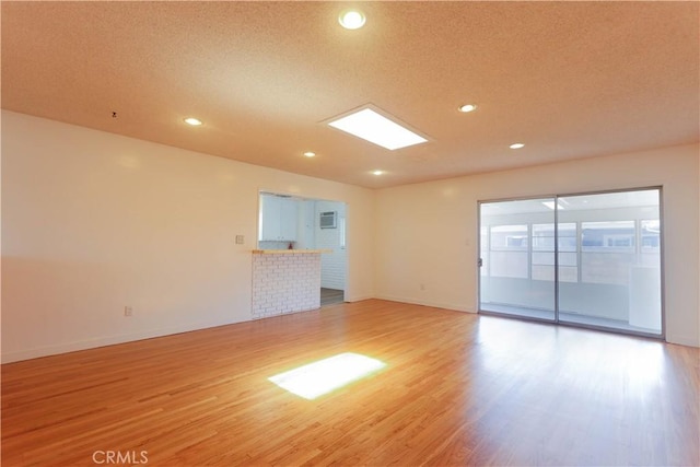 11618 Cedarvale St, Norwalk, CA 90650 - spare room with light wood-style floors, baseboards, recessed lighting, and a textured ceiling