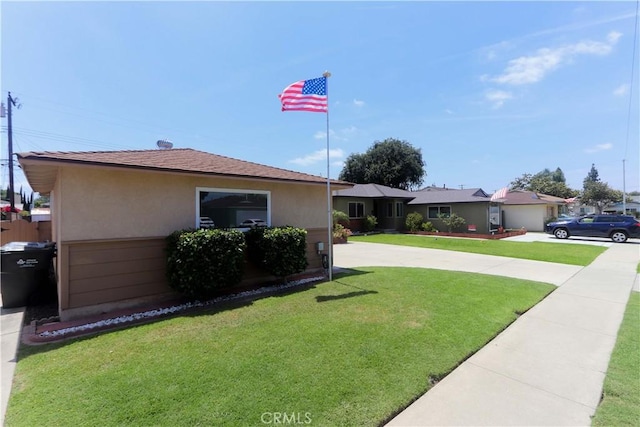11618 Cedarvale St, Norwalk, CA 90650 - view of property exterior with stucco siding, a lawn, and roof with shingles