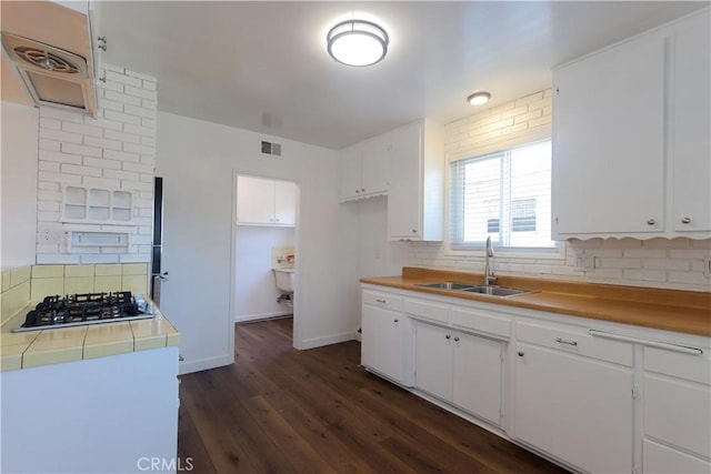 11618 Cedarvale St, Norwalk, CA 90650 - kitchen with a sink, stainless steel gas stovetop, tasteful backsplash, and white cabinets