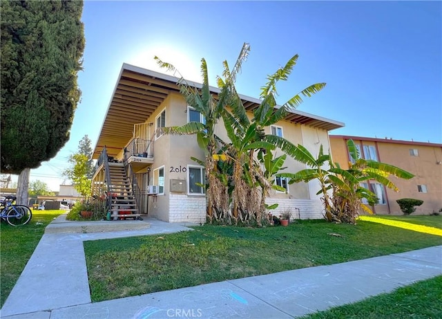 2010 La Cueva Dr, Rowland Heights, CA 91748 - view of front of property with a front yard, stairway, stucco siding, and cooling unit