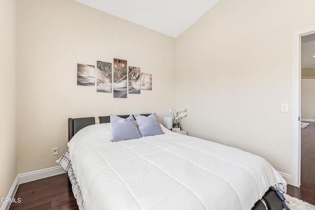 bedroom featuring wood finished floors, vaulted ceiling, and baseboards
