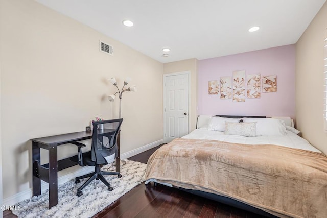 bedroom with dark wood-style flooring, baseboards, and recessed lighting
