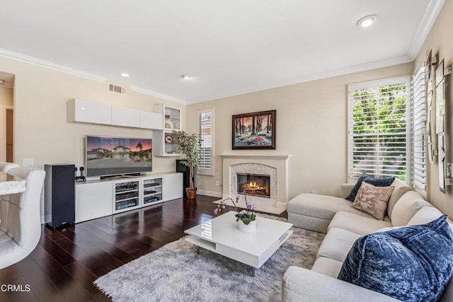 living room featuring dark wood-style flooring, ornamental molding, a premium fireplace, recessed lighting, and baseboards