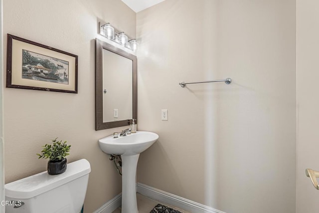 bathroom with toilet and a sink