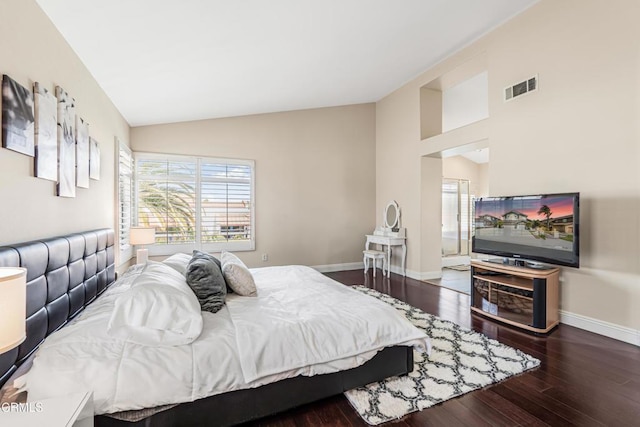 bedroom featuring multiple windows, hardwood / wood-style flooring, baseboards, and high vaulted ceiling