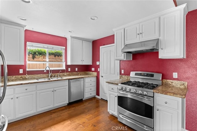 448 Grove Ln, Nipomo, CA 93444 - kitchen with under cabinet range hood, appliances with stainless steel finishes, a sink, white cabinetry, and recessed lighting