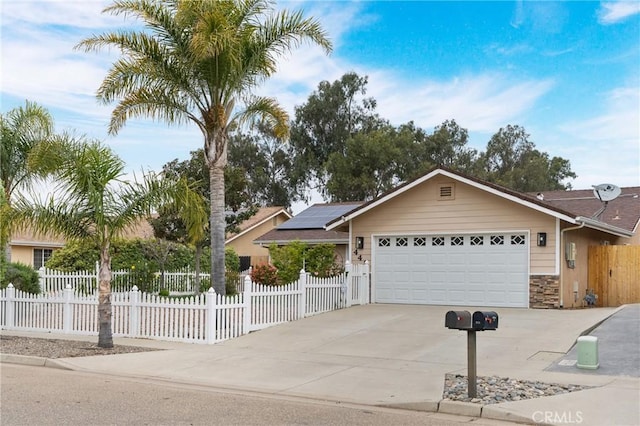 448 Grove Ln, Nipomo, CA 93444 - single story home with an attached garage, concrete driveway, roof mounted solar panels, a fenced front yard, and stone siding