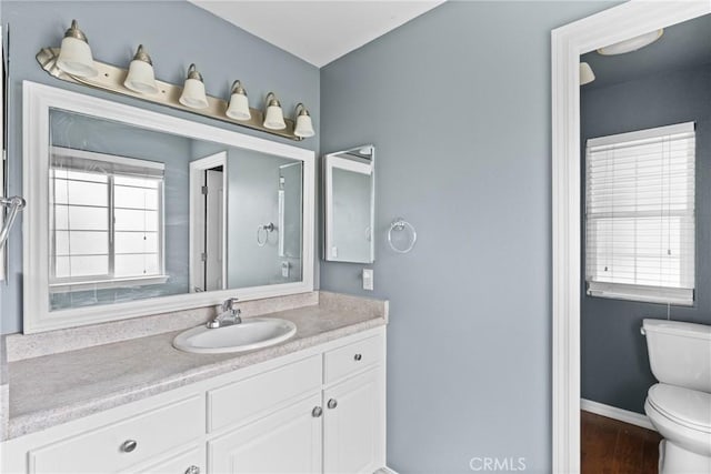 448 Grove Ln, Nipomo, CA 93444 - bathroom with toilet, vanity, wood finished floors, and baseboards