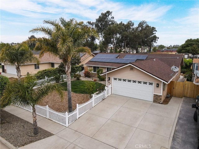 448 Grove Ln, Nipomo, CA 93444 - ranch-style house featuring driveway, stone siding, solar panels, an attached garage, and a shingled roof