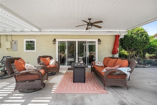 view of patio featuring an outdoor living space, ceiling fan, and fence