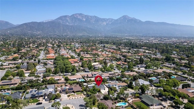 aerial view of property's location featuring a mountain backdrop and nearby suburban area
