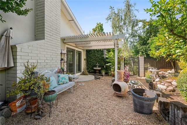view of yard featuring a pergola, fence, and a patio