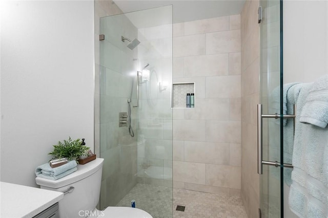 full bath with a shower stall, toilet, and vanity