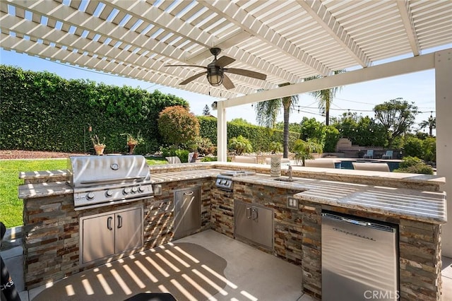 view of patio featuring area for grilling, a ceiling fan, a pergola, and an outdoor kitchen