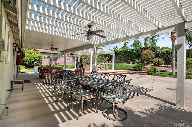 view of patio with outdoor dining space, a ceiling fan, a pergola, and fence