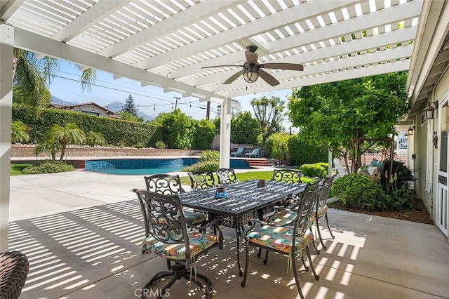 view of patio featuring outdoor dining area, a pergola, ceiling fan, and a fenced backyard