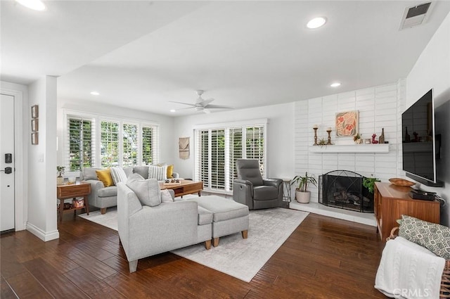living area featuring recessed lighting, hardwood / wood-style flooring, a ceiling fan, and a fireplace