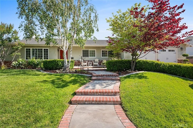 view of front facade featuring stucco siding and a front lawn