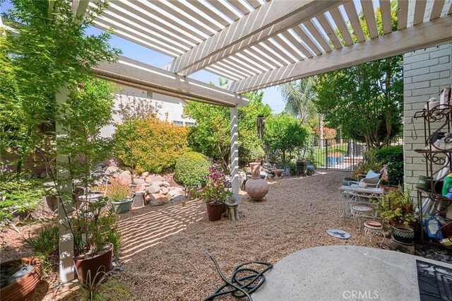 view of patio / terrace with fence and a pergola