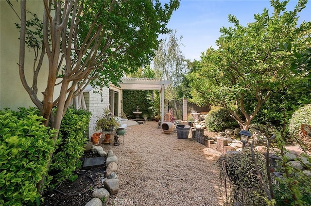 view of yard featuring a pergola and fence