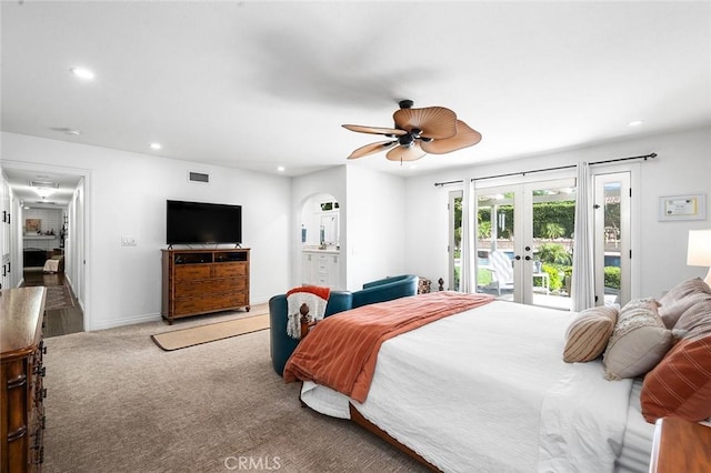 bedroom with access to outside, french doors, recessed lighting, carpet flooring, and arched walkways