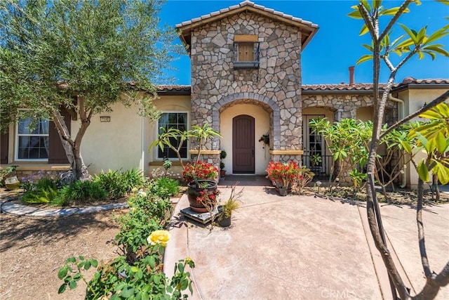 7940 Choi Dr, Riverside, CA 92506 - view of front of property featuring a tile roof, stucco siding, and stone siding