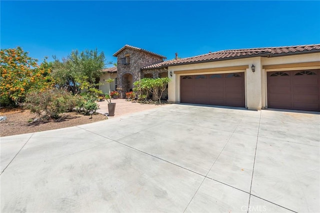 7940 Choi Dr, Riverside, CA 92506 - mediterranean / spanish-style home featuring concrete driveway, a garage, a tile roof, and stucco siding