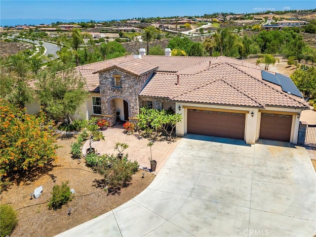 7940 Choi Dr, Riverside, CA 92506 - mediterranean / spanish home featuring an attached garage, a tile roof, stucco siding, and concrete driveway