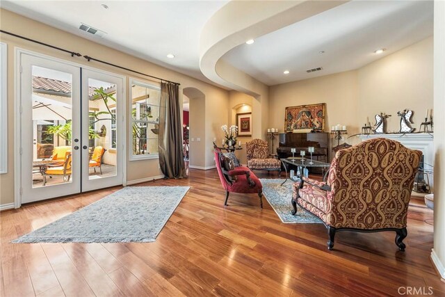 7940 Choi Dr, Riverside, CA 92506 - living room with arched walkways, wood finished floors, recessed lighting, baseboards, and french doors