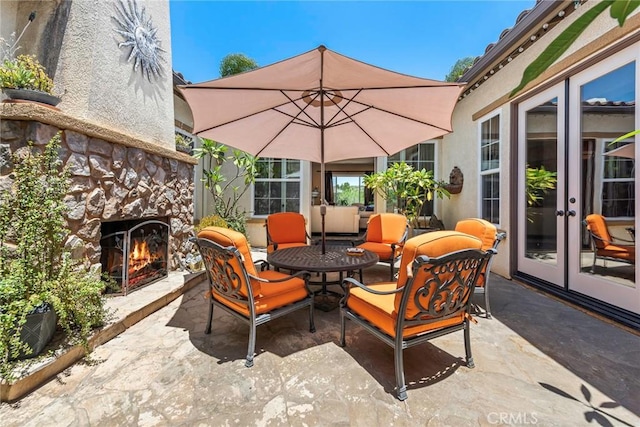 7940 Choi Dr, Riverside, CA 92506 - view of patio featuring a warm lit fireplace and french doors