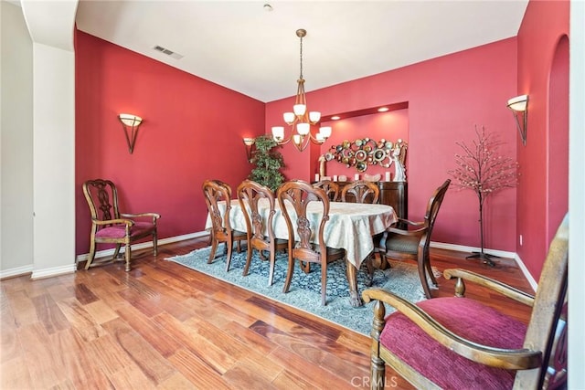 7940 Choi Dr, Riverside, CA 92506 - dining area featuring wood finished floors, a chandelier, and baseboards