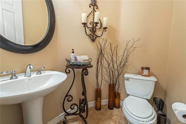 7940 Choi Dr, Riverside, CA 92506 - half bath featuring toilet, a sink, baseboards, and tile patterned flooring