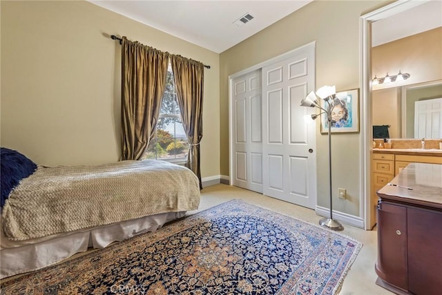 7940 Choi Dr, Riverside, CA 92506 - bedroom featuring a sink, a closet, baseboards, and ensuite bathroom
