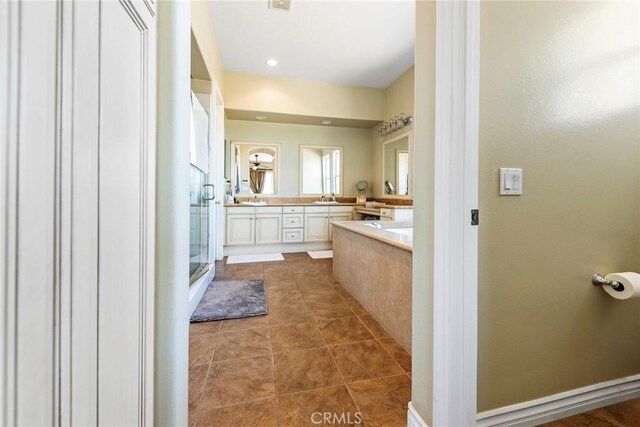 7940 Choi Dr, Riverside, CA 92506 - full bathroom with double vanity, a stall shower, a bathtub, and tile patterned floors