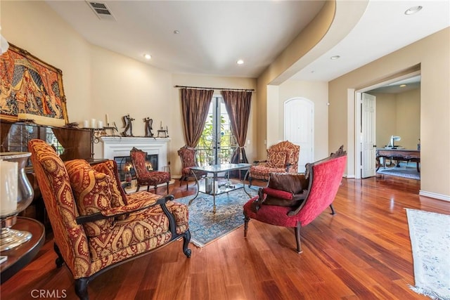 7940 Choi Dr, Riverside, CA 92506 - living room with wood finished floors, a glass covered fireplace, and recessed lighting