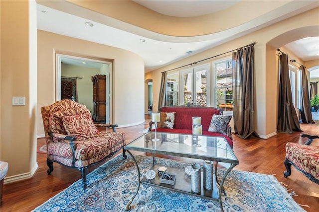 7940 Choi Dr, Riverside, CA 92506 - living room with arched walkways, baseboards, wood finished floors, and recessed lighting