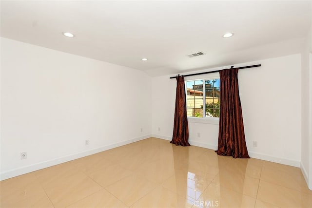 empty room featuring recessed lighting, baseboards, and light tile patterned floors