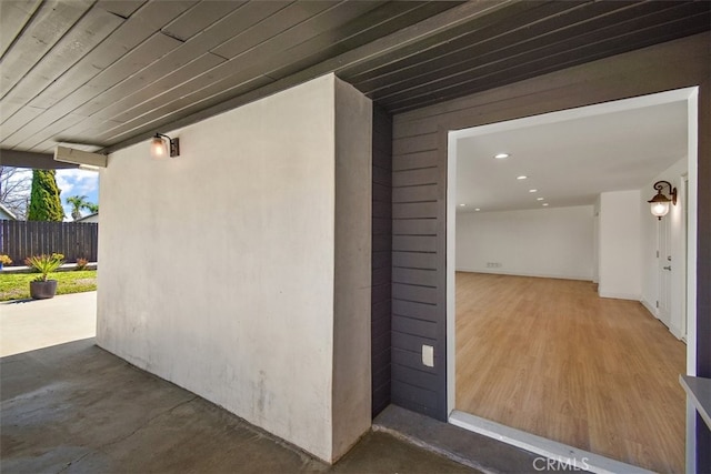 doorway to property featuring fence and a patio area