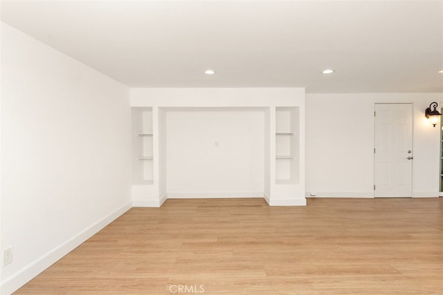 unfurnished room featuring built in features, baseboards, recessed lighting, and light wood-style flooring