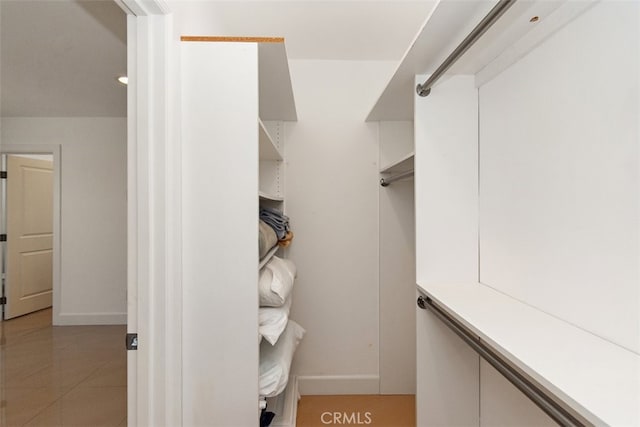 spacious closet featuring light tile patterned floors