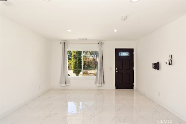 entryway with baseboards, recessed lighting, and light marble finish floors