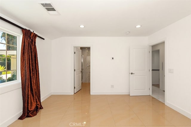 empty room featuring baseboards and recessed lighting