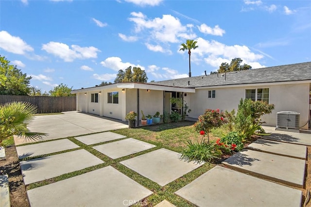 back of house with fence, a patio area, stucco siding, and central AC unit